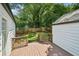 Backyard featuring wood deck and lush lawn with wooden privacy fence at 2485 Hillside Ave, Decatur, GA 30032