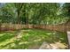 Fully fenced backyard featuring mature trees and lush green lawn at 2485 Hillside Ave, Decatur, GA 30032