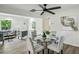 Bright dining area featuring modern decor, a ceiling fan, and a stylish glass-top table at 2485 Hillside Ave, Decatur, GA 30032