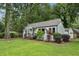 View of the home and landscaping with a well-kept lawn, bushes, trees and neutral-colored exterior paint at 2485 Hillside Ave, Decatur, GA 30032