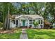 Charming renovated bungalow featuring a new roof, stylish green door, and a lush front yard at 2485 Hillside Ave, Decatur, GA 30032
