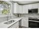 Well-lit kitchen showcasing a deep sink, modern appliances, and elegant backsplash at 2485 Hillside Ave, Decatur, GA 30032