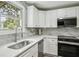 Close-up of kitchen showcasing marble countertops, stainless steel appliances, and modern fixtures at 2485 Hillside Ave, Decatur, GA 30032