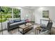 Inviting living room featuring neutral tones, large windows with views, and comfortable seating at 2485 Hillside Ave, Decatur, GA 30032
