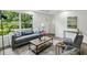 Comfortable living room with a gray sofa, modern decor, and plenty of natural light at 2485 Hillside Ave, Decatur, GA 30032