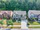An aerial view of a beautiful home featuring a well-manicured lawn, complementing its neighborhood at 2525 Well Springs Dr, Buford, GA 30519