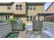 Landscaped backyard with a stone patio, garden beds, and rear view of the beautiful two-story home at 2525 Well Springs Dr, Buford, GA 30519