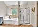Bright bathroom featuring a large soaking tub and glass enclosed shower at 2525 Well Springs Dr, Buford, GA 30519