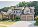 Charming two-story brick home with a well-manicured lawn, two car garage, and inviting front porch at 2525 Well Springs Dr, Buford, GA 30519