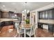 Bright kitchen with granite countertops, stainless appliances, rich wood cabinets, island, and adjacent dining area at 2525 Well Springs Dr, Buford, GA 30519
