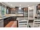 Modern kitchen features granite countertops, stainless appliances, dark cabinets, tiled backsplash, and a breakfast bar at 2525 Well Springs Dr, Buford, GA 30519