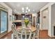 Open-concept kitchen and dining area with wood floors, stainless steel appliances, and plenty of natural light at 2525 Well Springs Dr, Buford, GA 30519