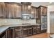 Modern kitchen showcasing dark wood cabinets, granite countertops, tiled backsplash, and stainless steel appliances at 2525 Well Springs Dr, Buford, GA 30519