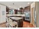 Modern kitchen features granite countertops, stainless appliances, dark cabinets, and a breakfast bar with bar stool seating at 2525 Well Springs Dr, Buford, GA 30519