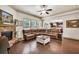 Spacious living room featuring hardwood floors, stone fireplace, and comfortable leather furniture at 2525 Well Springs Dr, Buford, GA 30519