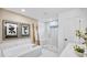 Elegant bathroom with a soaking tub, glass-enclosed shower, and modern fixtures, offering a spa-like experience at 5769 Tillman Way, Powder Springs, GA 30127