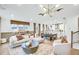 Open concept living space with modern furnishings, wood floors, and ample natural light, ideal for entertaining at 5769 Tillman Way, Powder Springs, GA 30127