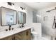 Elegant bathroom with double sinks, marble countertops, and a glass-enclosed shower at 888 Tucker Rd, Stone Mountain, GA 30087