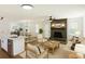 Open-concept living space featuring modern furnishings and a cozy brick fireplace at 888 Tucker Rd, Stone Mountain, GA 30087