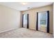 Well-lit bedroom showcasing ample space, cozy carpet, and natural light through large windows at 99 Rainwater Ln, Dallas, GA 30157