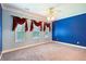 Spacious bedroom featuring blue accent wall, carpet floors, and ample natural light at 99 Rainwater Ln, Dallas, GA 30157