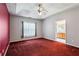Primary bedroom with carpet, ceiling fan, and large windows for ample natural light and a doorway to the bathroom at 99 Rainwater Ln, Dallas, GA 30157