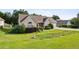 Ranch-style home featuring a well-kept lawn and mature landscaping with an attached garage at 99 Rainwater Ln, Dallas, GA 30157