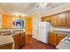 Spacious kitchen with a refrigerator, white gas range, stainless steel sink, and wood cabinets at 99 Rainwater Ln, Dallas, GA 30157