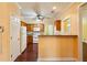 Bright kitchen with wood cabinets, white appliances, bar seating, and view of nearby rooms at 99 Rainwater Ln, Dallas, GA 30157