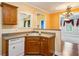 Classic kitchen with a stainless steel sink, wood cabinets, and view of the nearby living area at 99 Rainwater Ln, Dallas, GA 30157