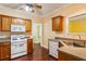 Traditional-style kitchen featuring a white gas range, oak cabinets, and dark hardwood flooring at 99 Rainwater Ln, Dallas, GA 30157