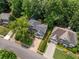 An aerial view showcases the property's manicured lawn, mature trees, and desirable location within a peaceful neighborhood at 1205 Compass Pointe Xing, Alpharetta, GA 30005