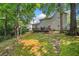A beautiful backyard features mature trees, a deck and a swing set at 1205 Compass Pointe Xing, Alpharetta, GA 30005