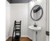 Compact powder room features pedestal sink, an oval mirror, and unique wainscoting at 1205 Compass Pointe Xing, Alpharetta, GA 30005