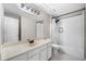Updated bathroom with white subway tile shower and modern vanity with a black framed mirror at 1205 Compass Pointe Xing, Alpharetta, GA 30005