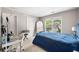 Bedroom featuring a cozy atmosphere, a bed with blue bedding, a desk area, and a view of the street at 1205 Compass Pointe Xing, Alpharetta, GA 30005