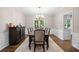 Dining room featuring a classic table setting, dark wood furniture, neutral walls, and elegant chandelier at 1205 Compass Pointe Xing, Alpharetta, GA 30005
