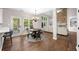 Bright dining area adjacent to the living room features a round table and backyard access at 1205 Compass Pointe Xing, Alpharetta, GA 30005