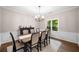 Elegant dining room with modern table setting, classic trim work, neutral paint, and natural light from the windows at 1205 Compass Pointe Xing, Alpharetta, GA 30005