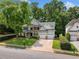 Charming two-story home with stone accents, lush landscaping, and a two-car garage at 1205 Compass Pointe Xing, Alpharetta, GA 30005