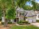 Charming two-story home featuring a stone facade, three car garage, and inviting landscaped front yard at 1205 Compass Pointe Xing, Alpharetta, GA 30005