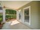 Inviting front porch with classic design, a supportive column, and picturesque views of the well-kept greenery at 1205 Compass Pointe Xing, Alpharetta, GA 30005