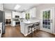 Bright kitchen featuring white cabinets, stainless appliances, and adjacent breakfast bar at 1205 Compass Pointe Xing, Alpharetta, GA 30005