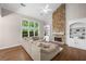 Bright living room with a stone fireplace, vaulted ceilings, and oversized windows at 1205 Compass Pointe Xing, Alpharetta, GA 30005