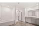 Elegant bathroom featuring a tub, walk-in shower, double vanity and modern fixtures at 1309 Aura Ln, Lawrenceville, GA 30045