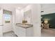 Elegant bathroom featuring a double sink vanity and a bedroom view at 1309 Aura Ln, Lawrenceville, GA 30045
