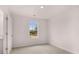 Bright bedroom with a window and neutral walls and floors, ready for personalization at 1309 Aura Ln, Lawrenceville, GA 30045