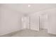 Unfurnished bedroom showing neutral carpet, two doors, and walk in closet space at 1309 Aura Ln, Lawrenceville, GA 30045