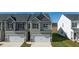 Charming townhome featuring an attached garage and neutral siding in a well-maintained community at 1309 Aura Ln, Lawrenceville, GA 30045