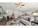 Open living room with modern decor, adjacent to a kitchen and a staircase at 1309 Aura Ln, Lawrenceville, GA 30045
